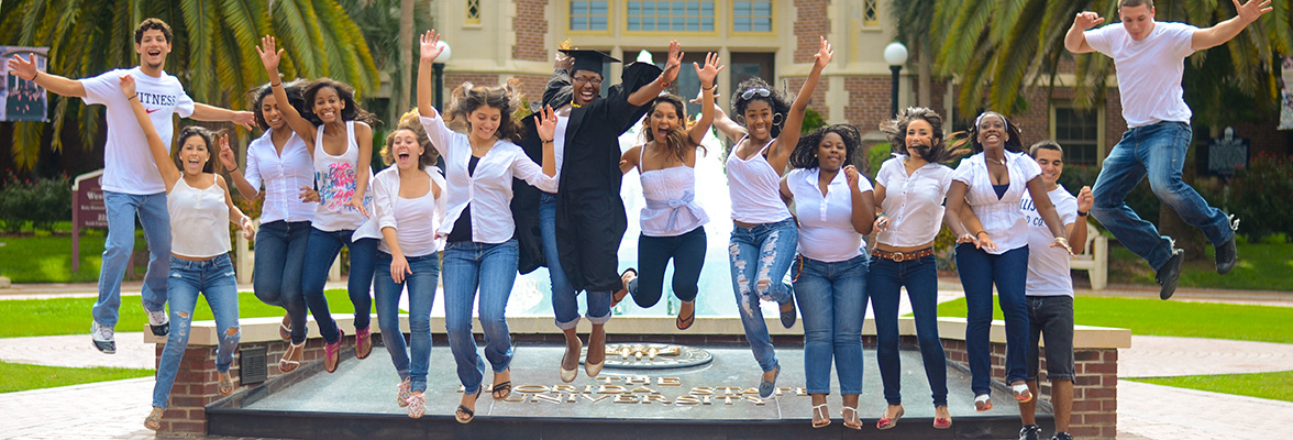 CARE students jumping in front of the Westcott building