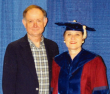 Jay and Dr. Sue Newman posing at her graduate ceremony